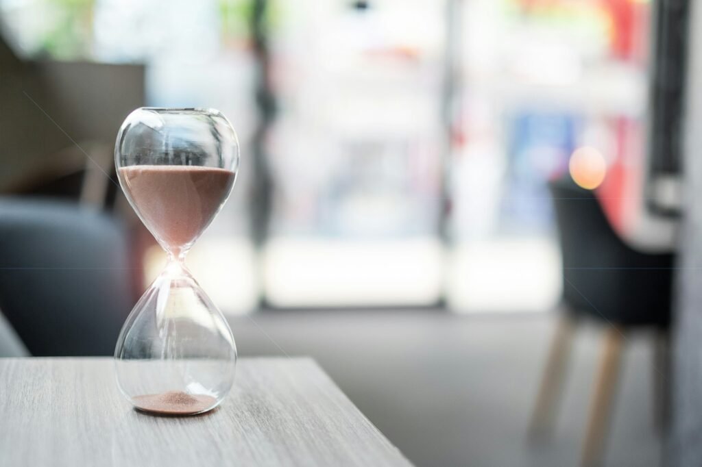 Hourglass on table office with copy space